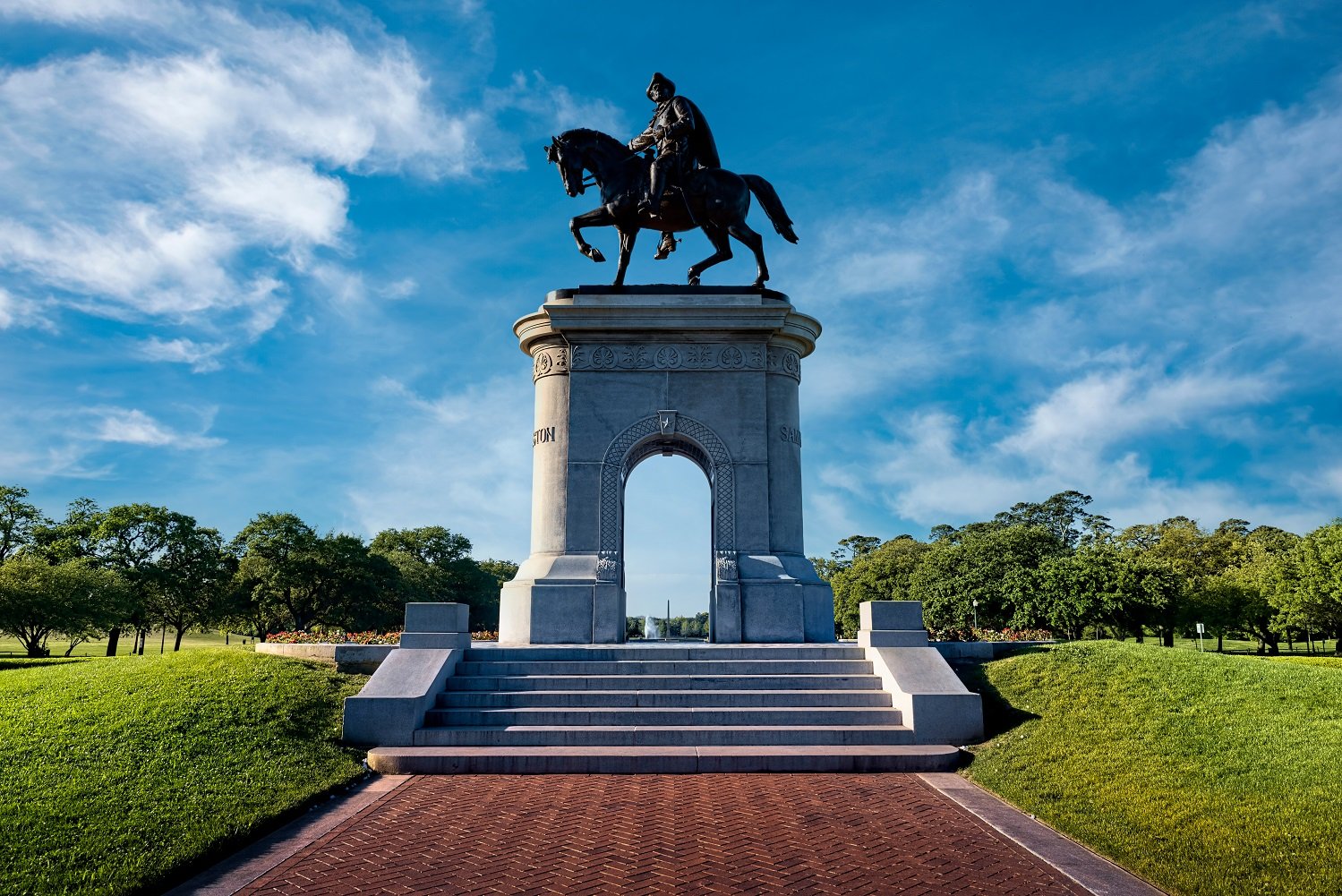 A statue of a person riding a horse on a pedestal.