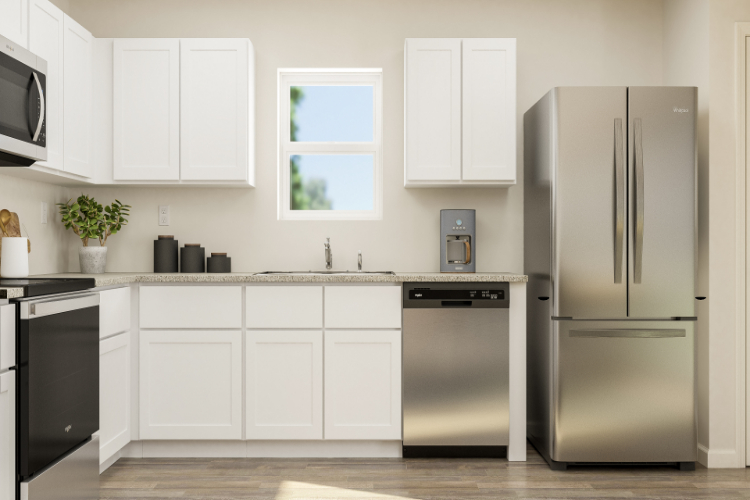 A kitchen with white cabinets.