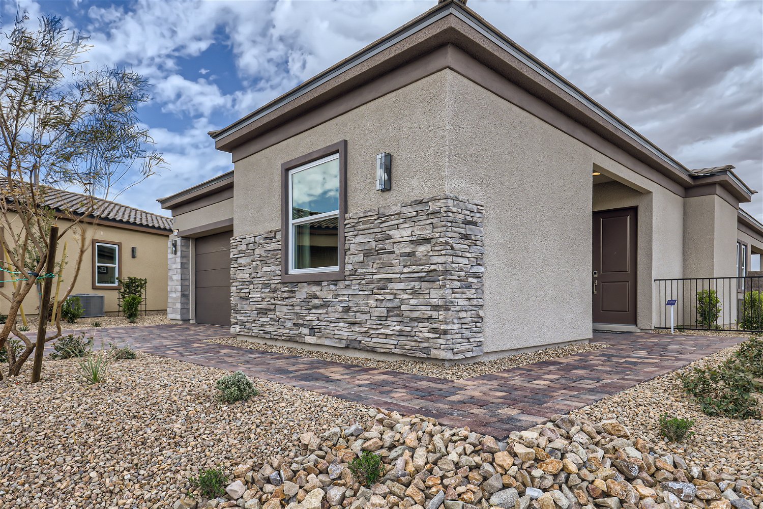 A stone house with a stone driveway.