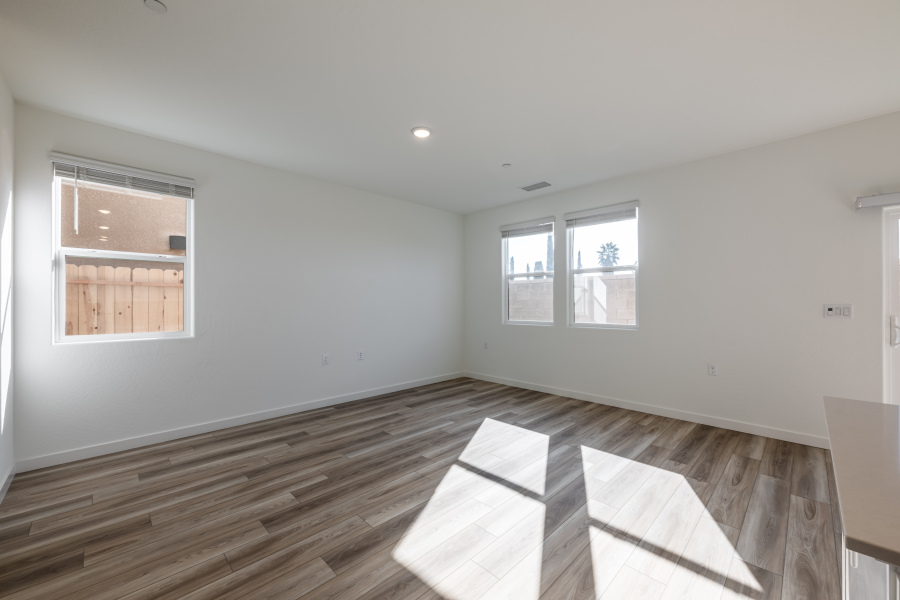 A room with windows and a rug.
