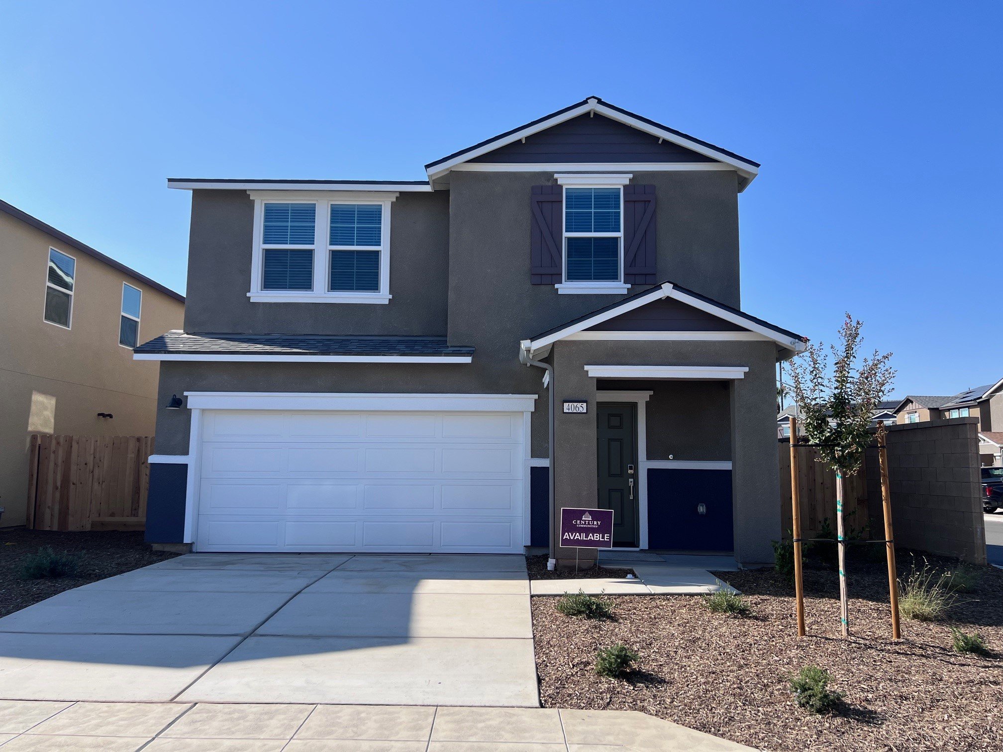 A house with garages and a sidewalk.