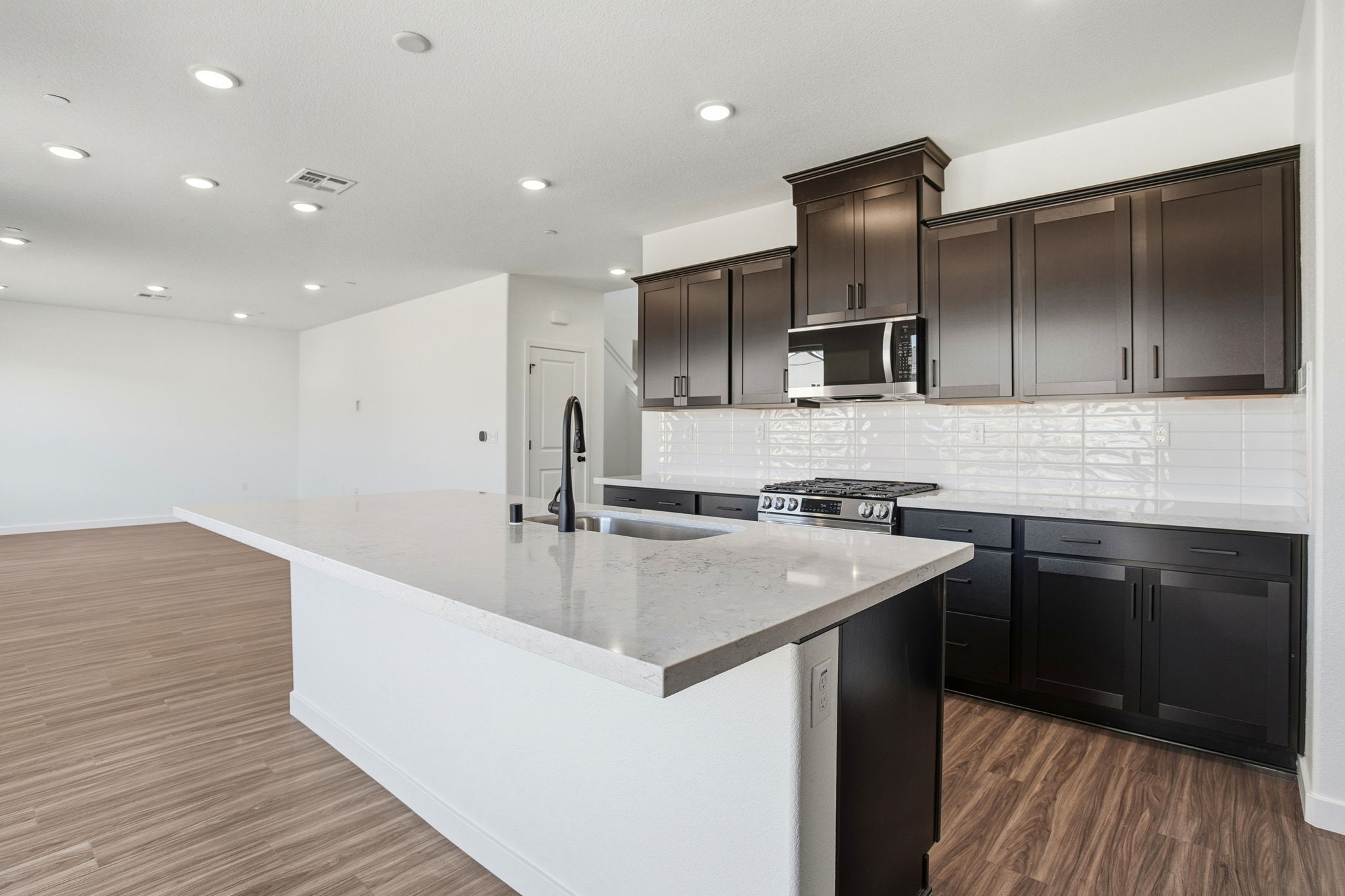 A kitchen with black cabinets.
