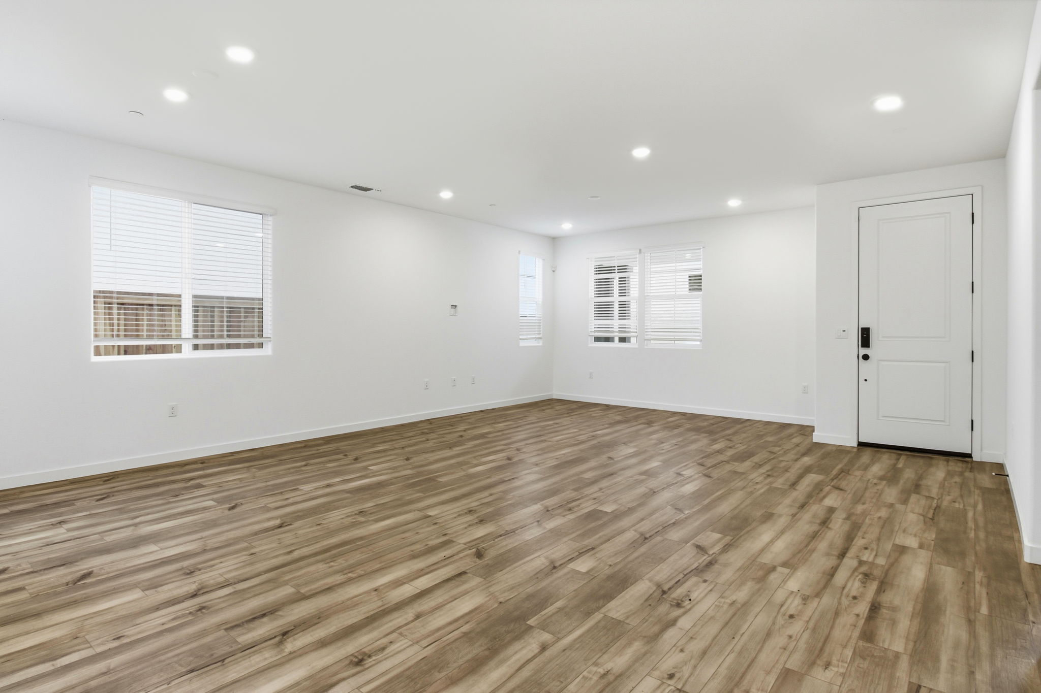 A room with a wood floor and white walls.