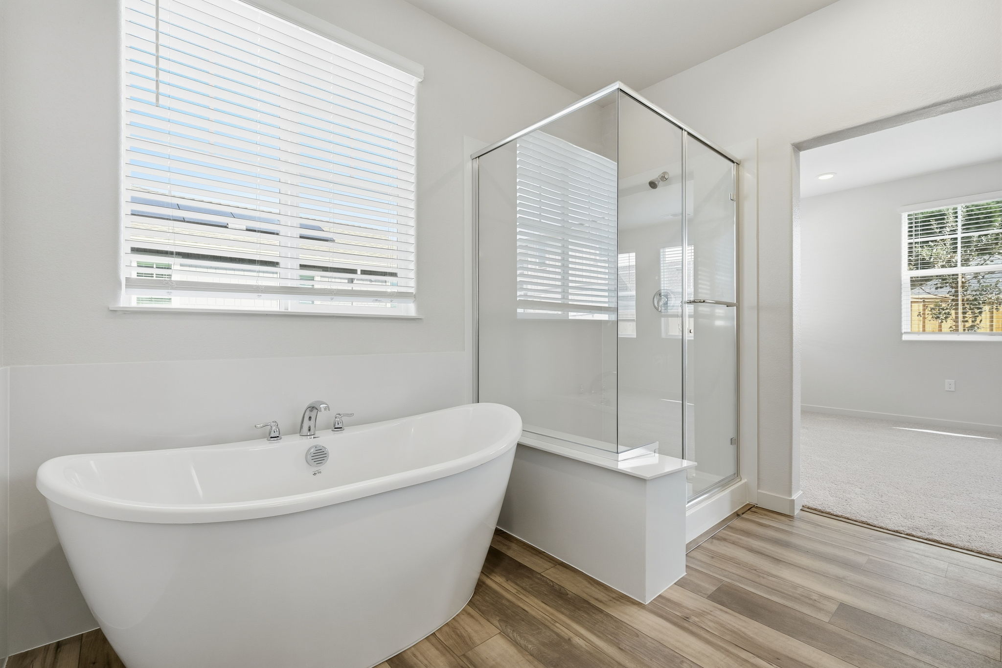 A bathroom with a tub and a shower.