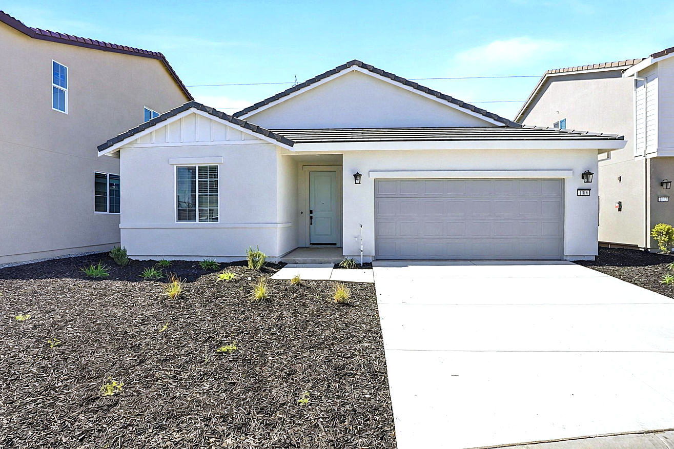 A white house with a garage.