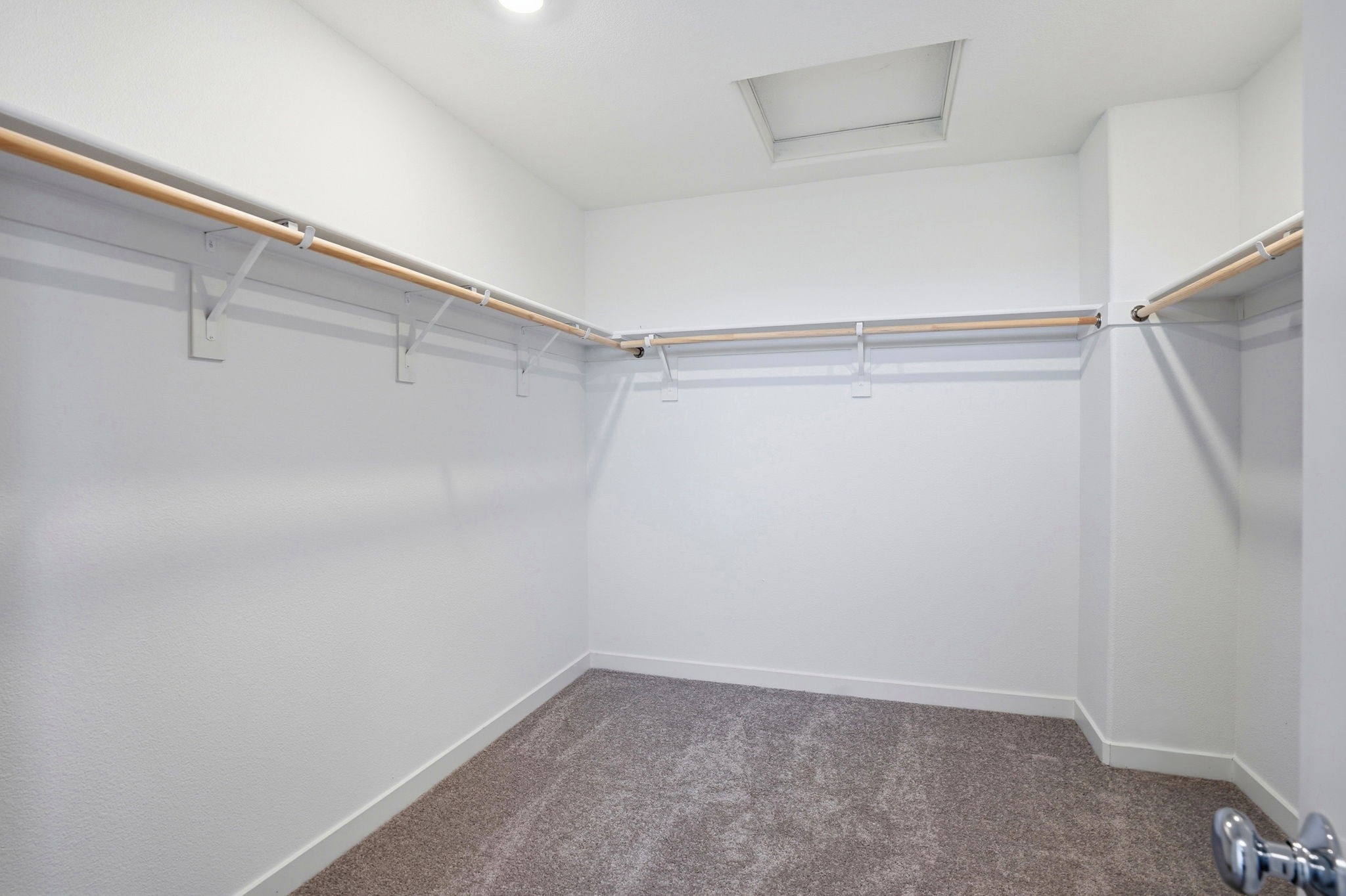 A white room with a metal railing.