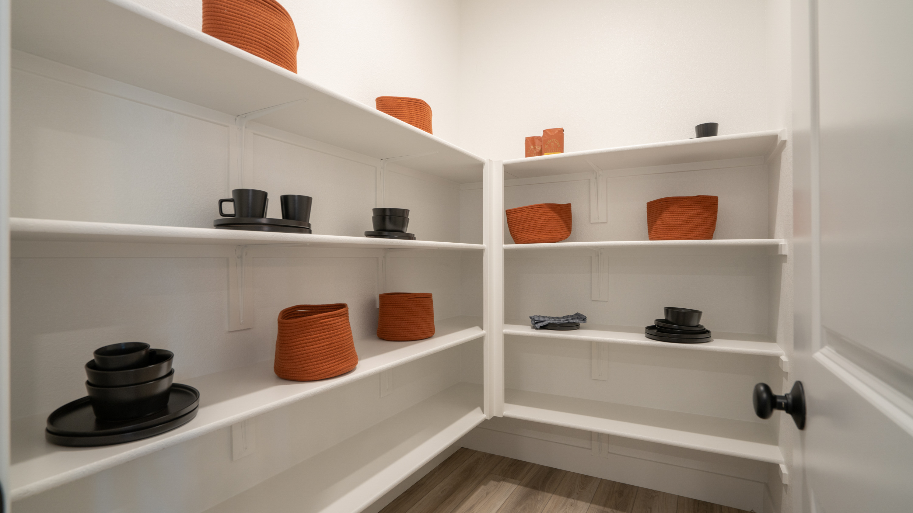 A white shelving unit with various objects on it.