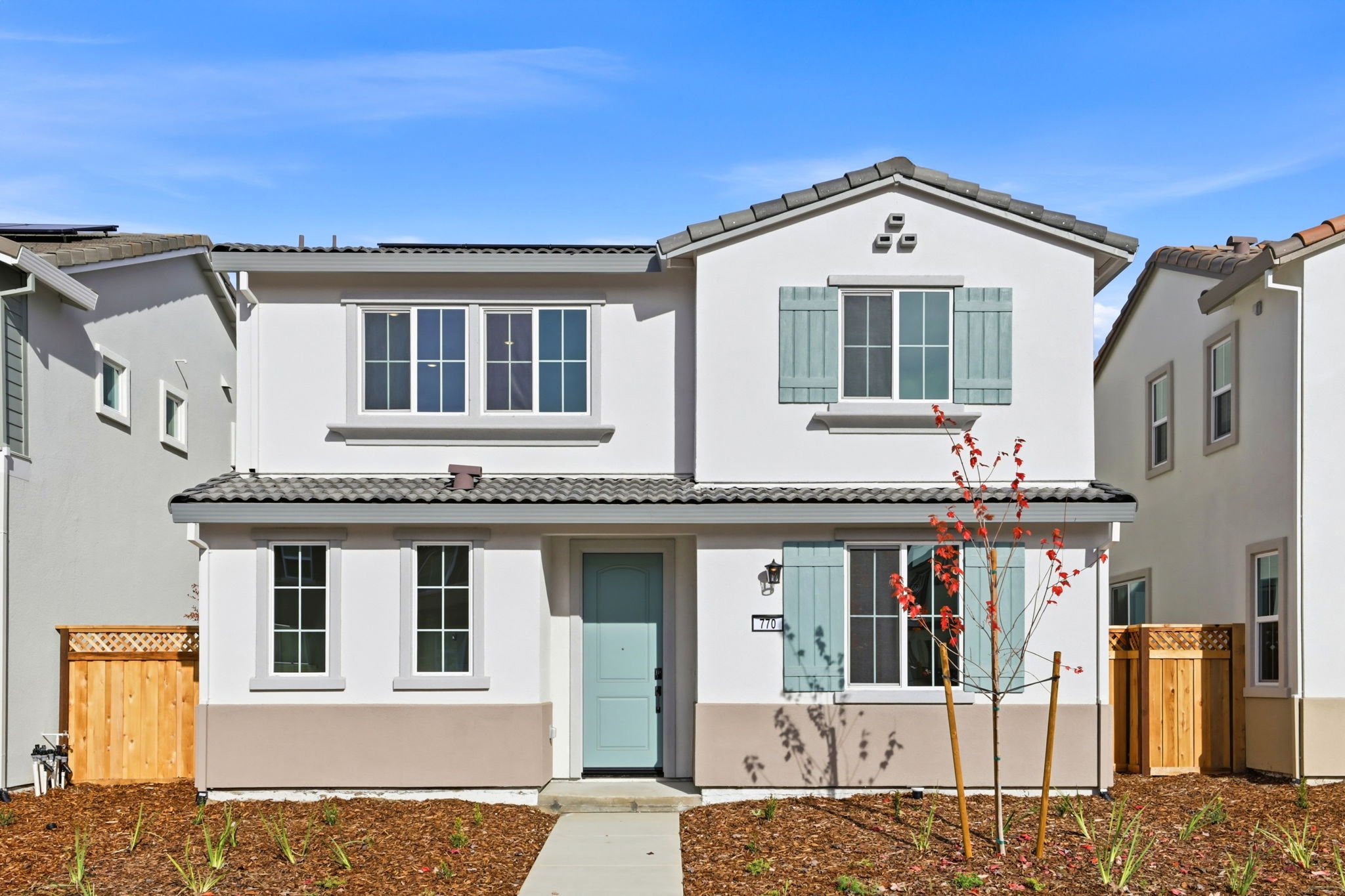 A white house with blue doors.
