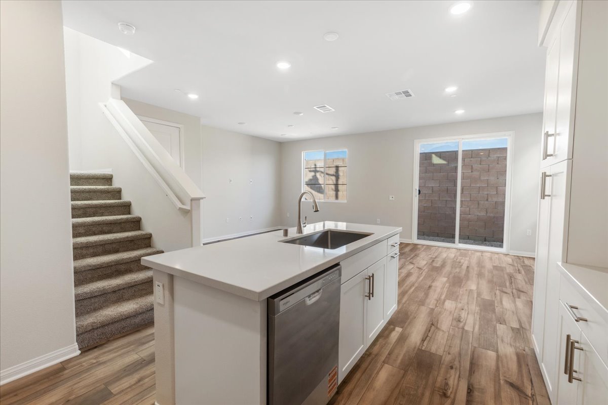 A kitchen with white cabinets.