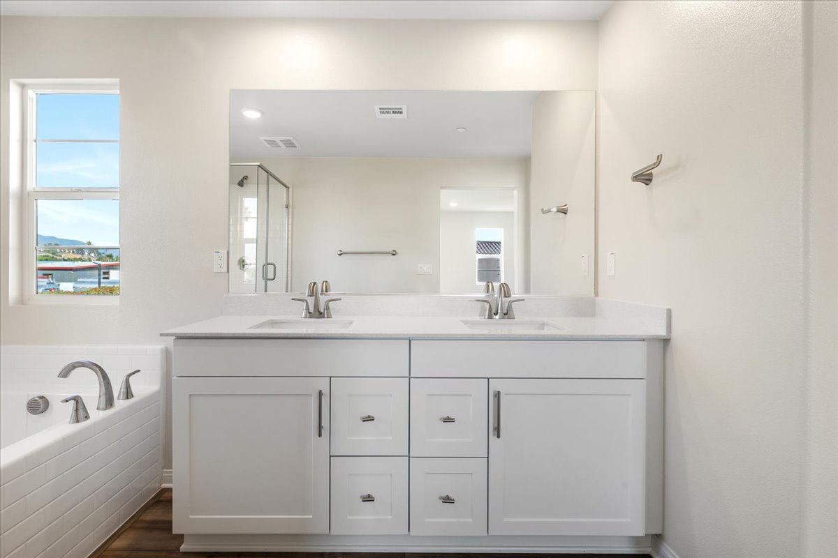A bathroom with white cabinets.