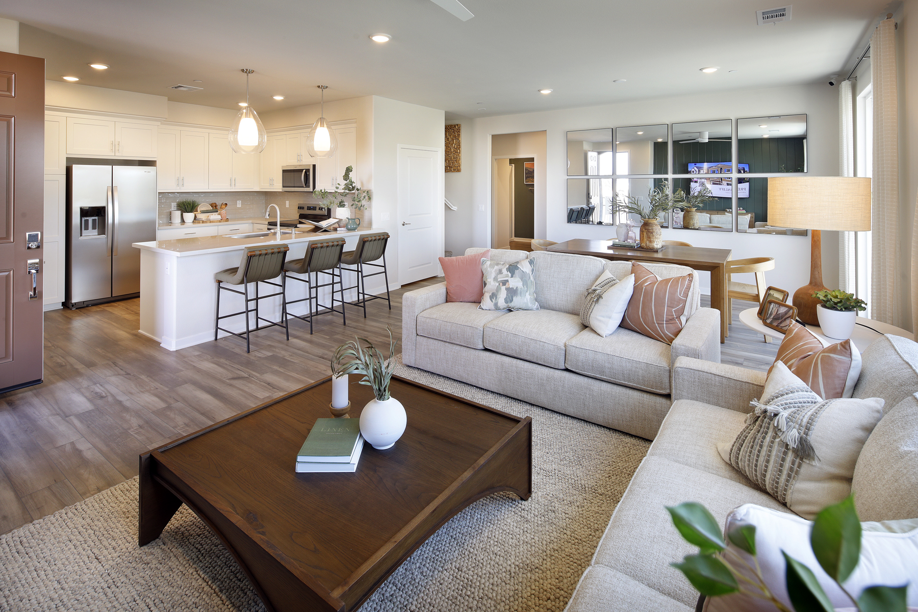 A living room with a large kitchen.