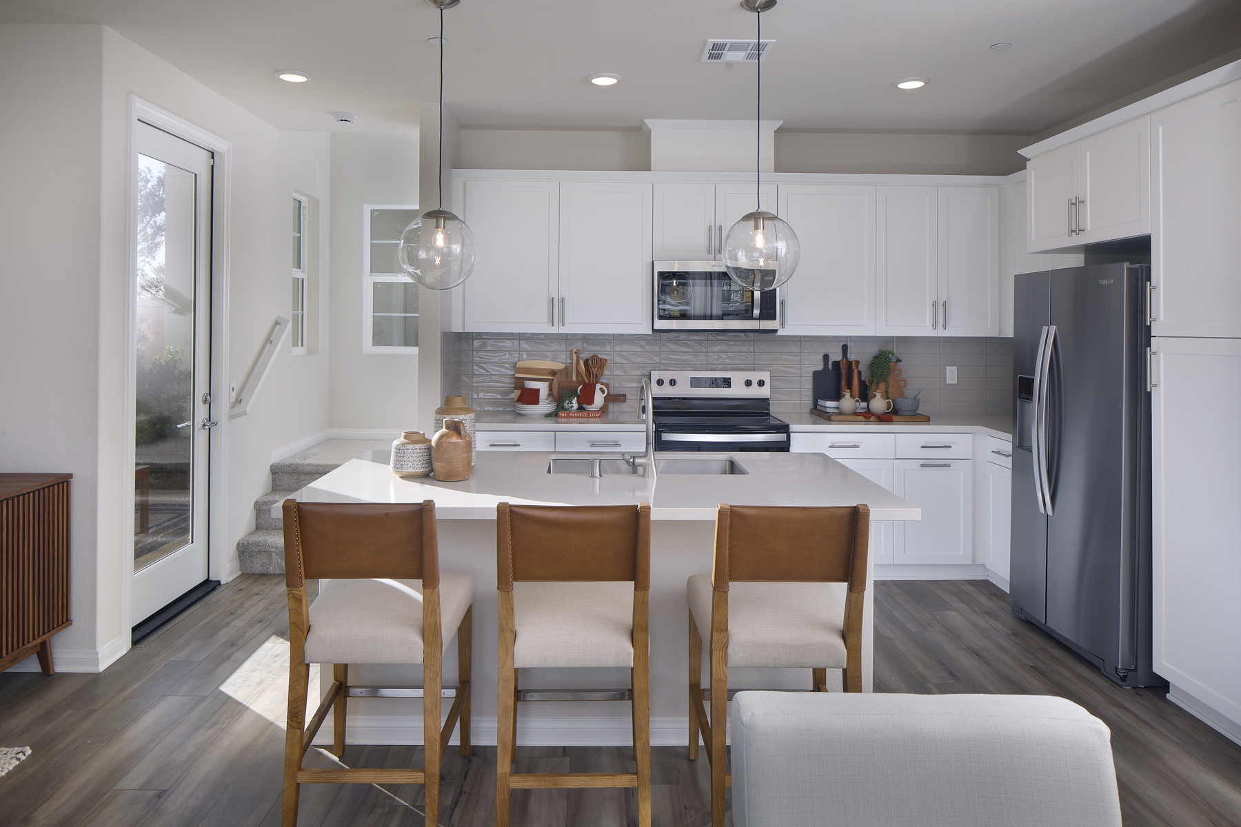 A kitchen with white cabinets.