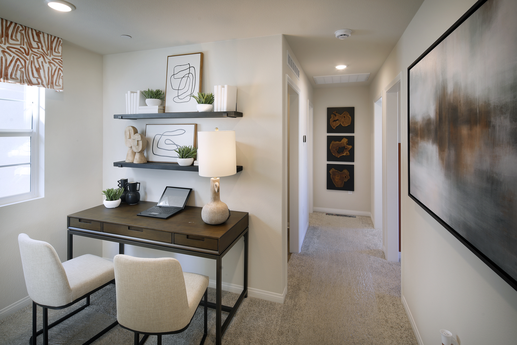 A room with a desk and chairs.