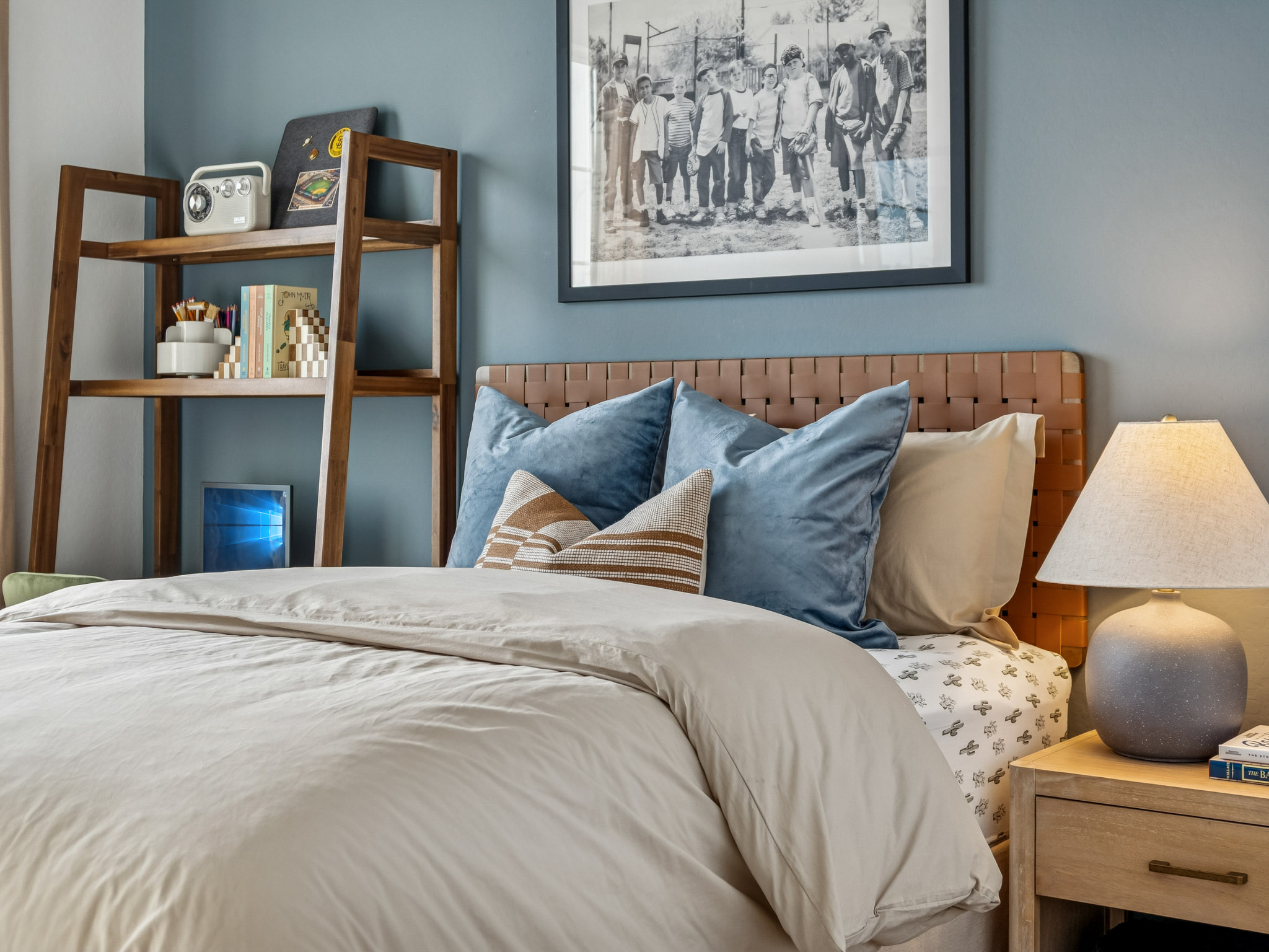 A bed with blue pillows.