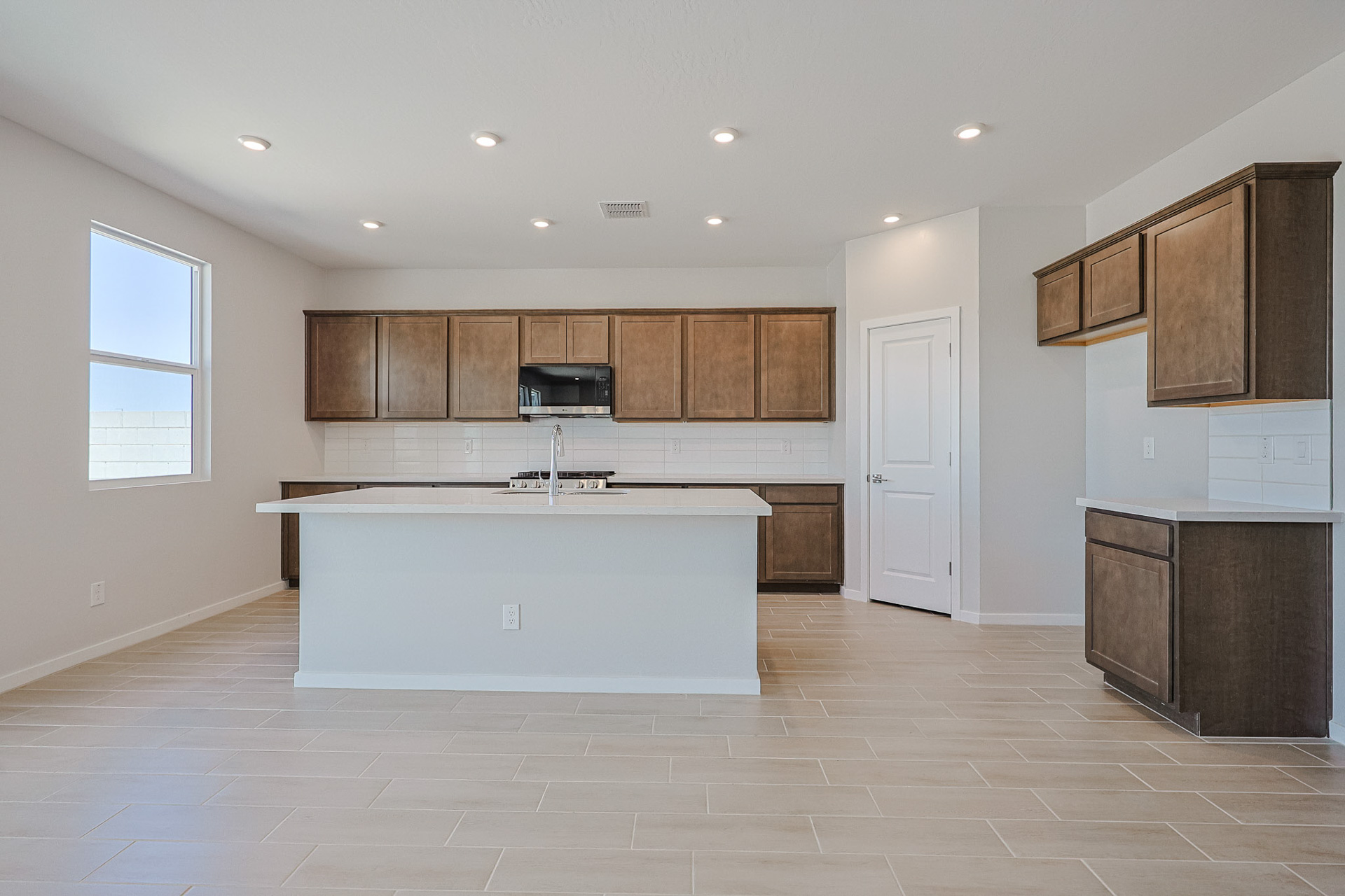 A kitchen with wooden cabinets.