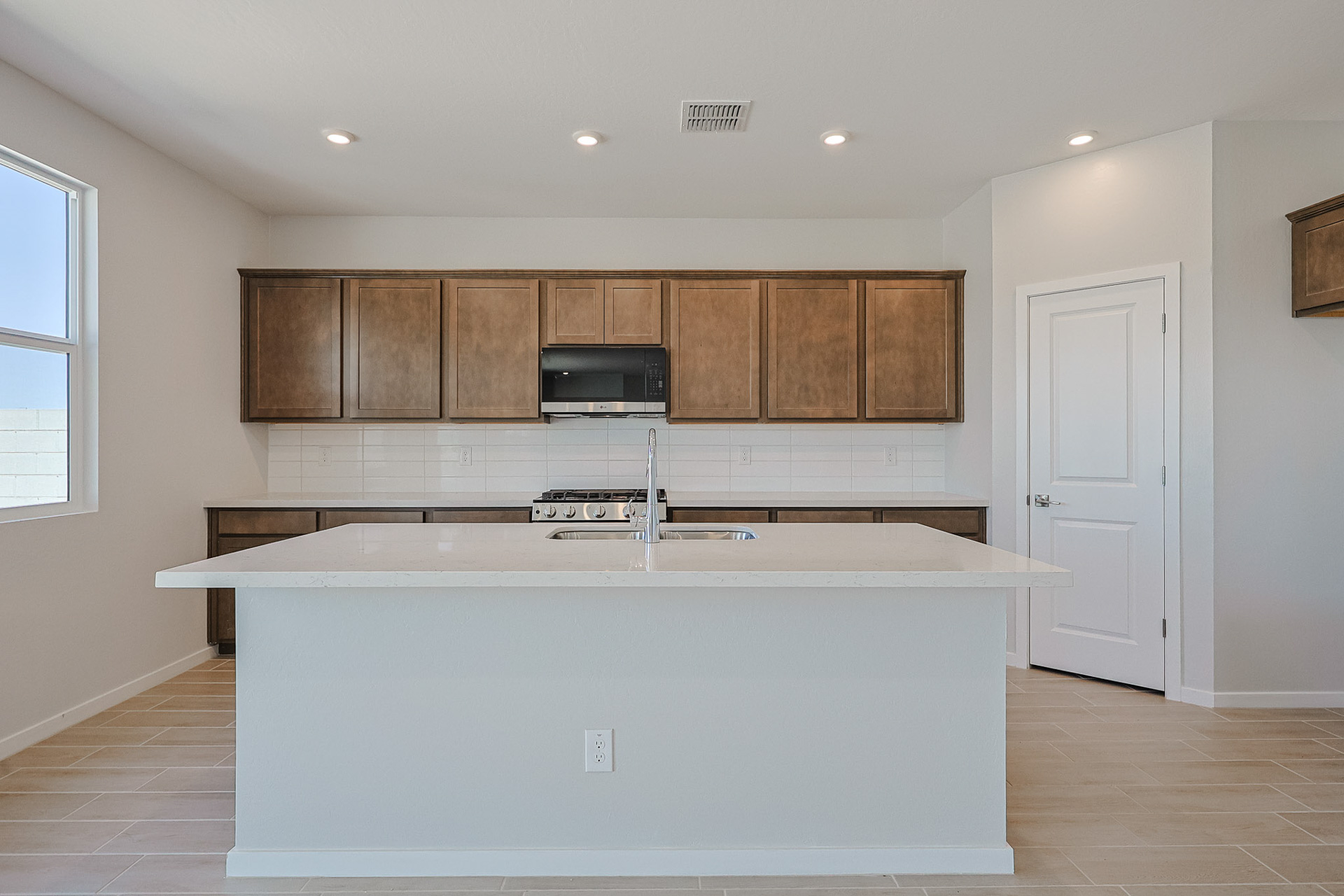 A kitchen with wooden cabinets.