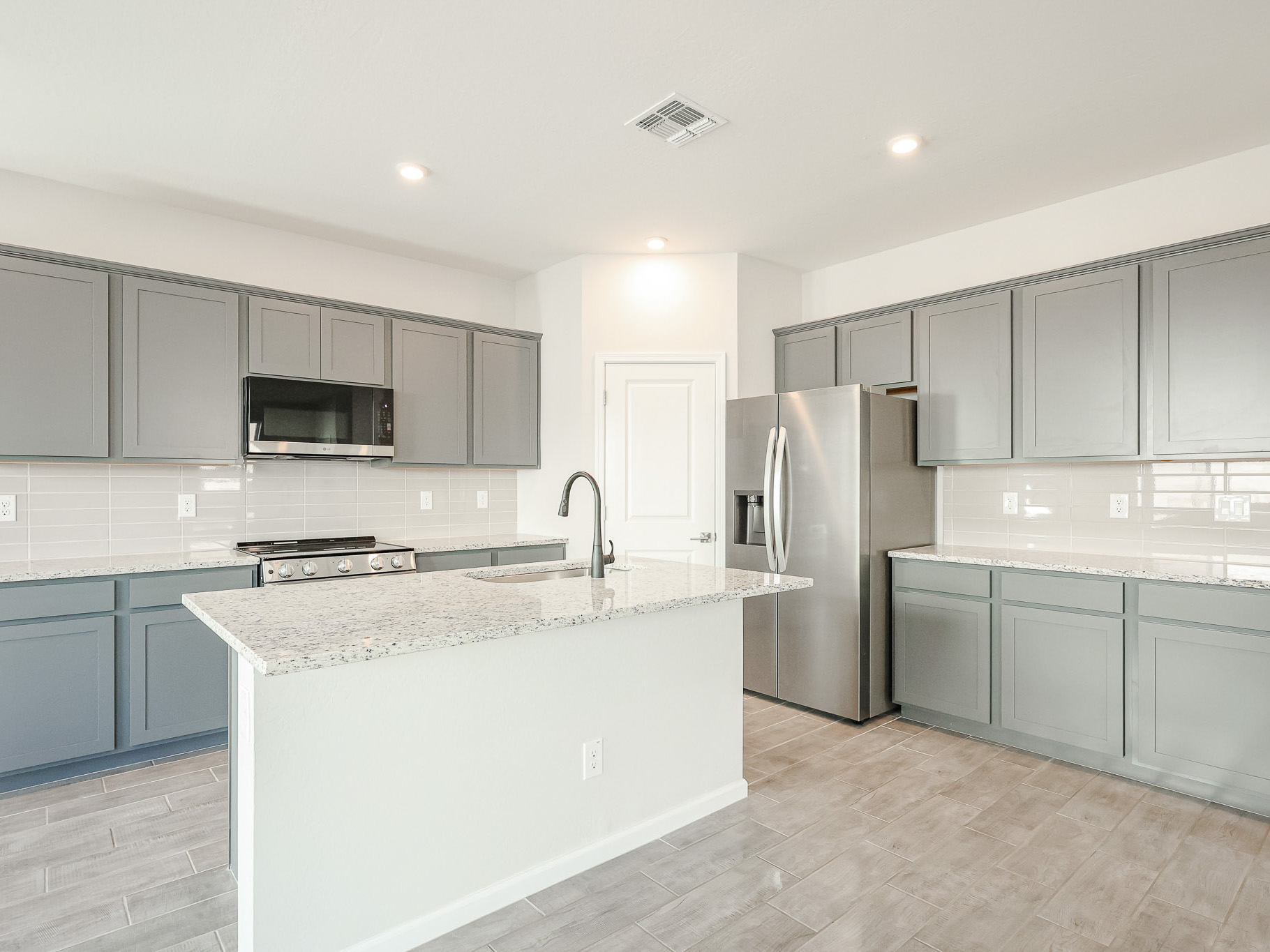 A kitchen with white cabinets.