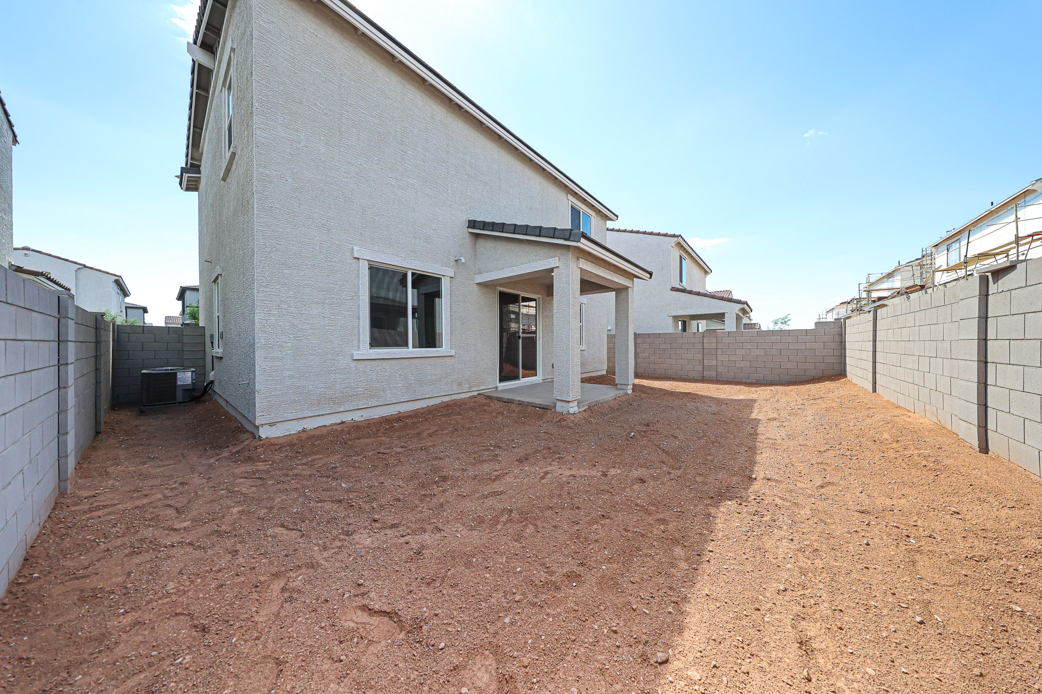 A dirt road between buildings.