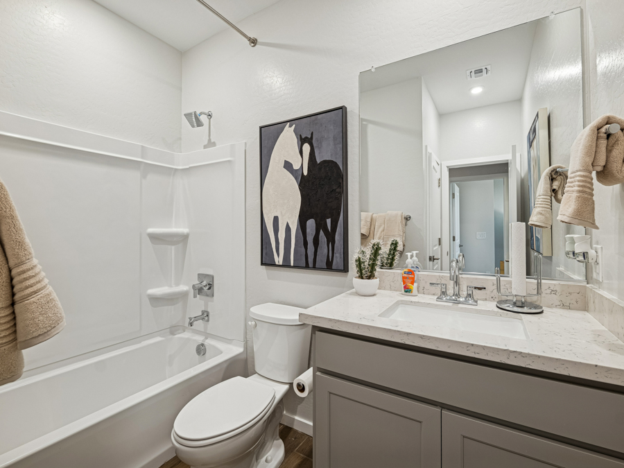 A bathroom with a large mirror.