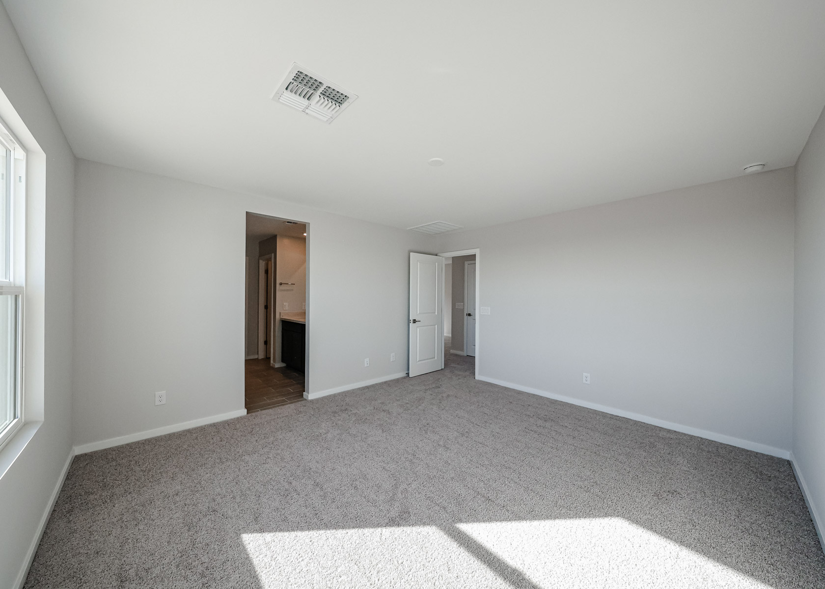 A hallway with white walls.