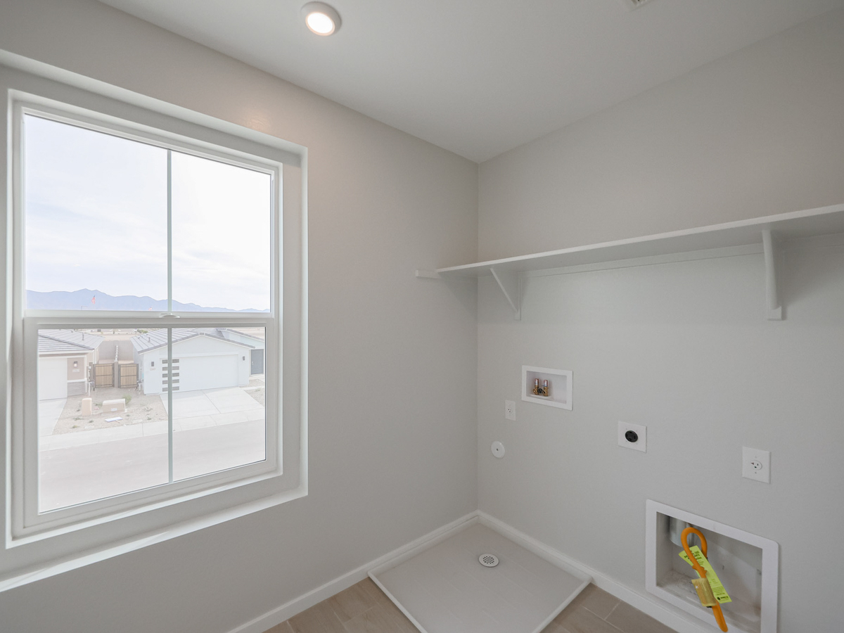 A bathroom with a tub and a window.