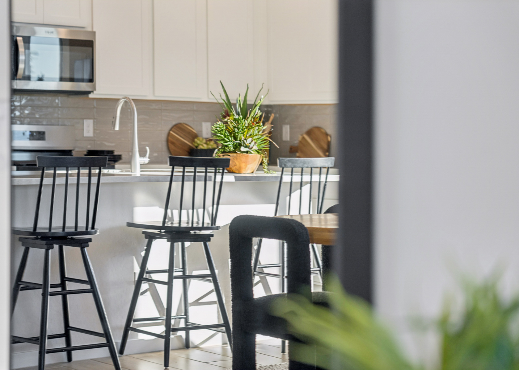 A kitchen with a table and chairs.