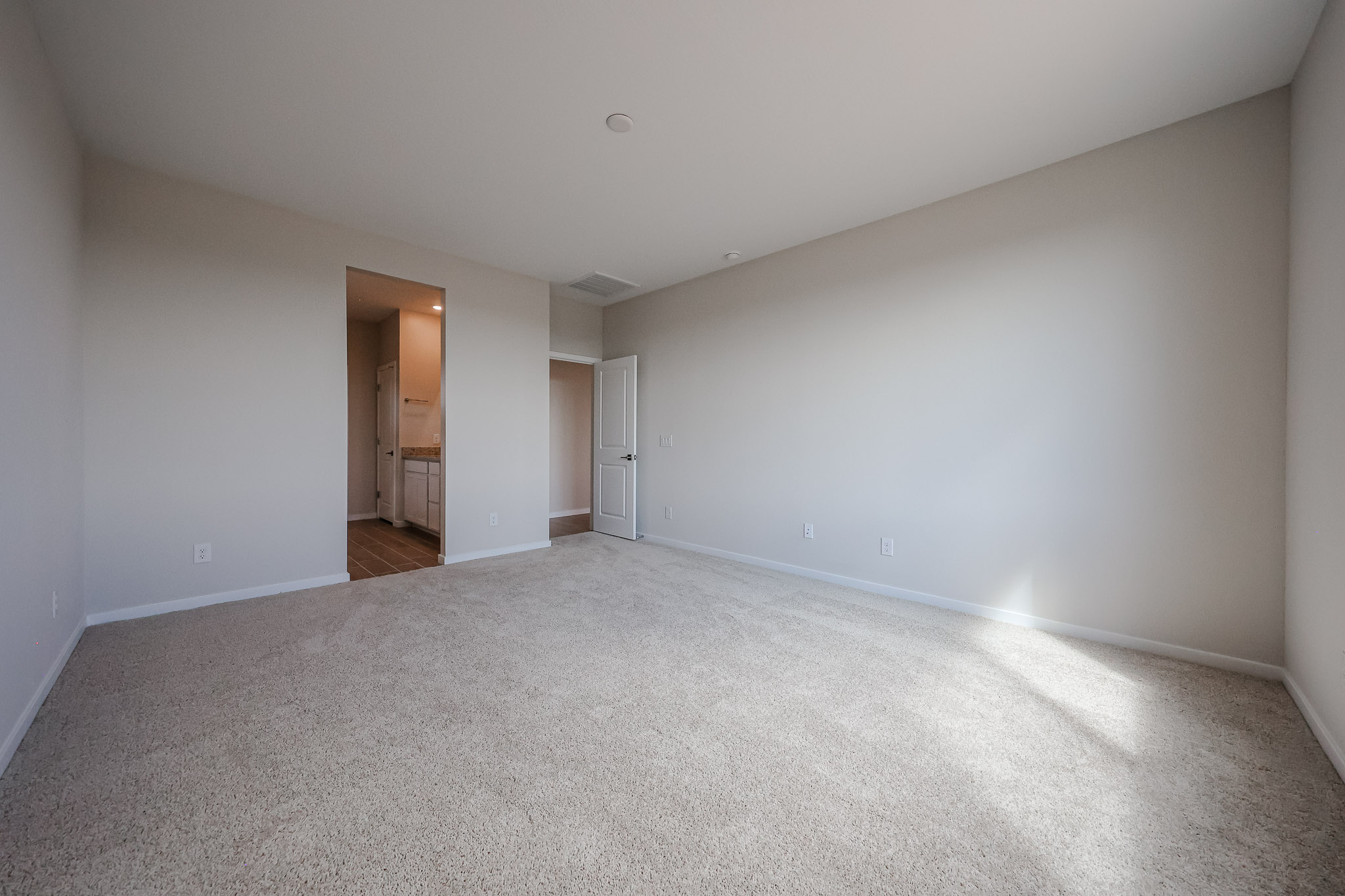 A long hallway with white walls.