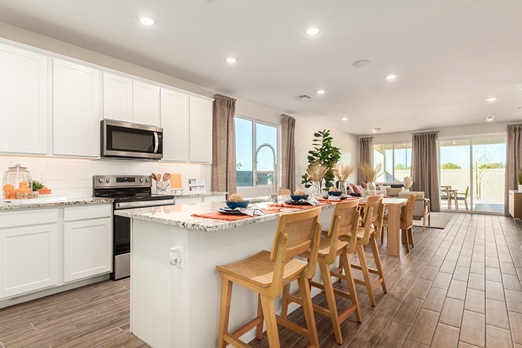 A kitchen with a dining table and chairs.