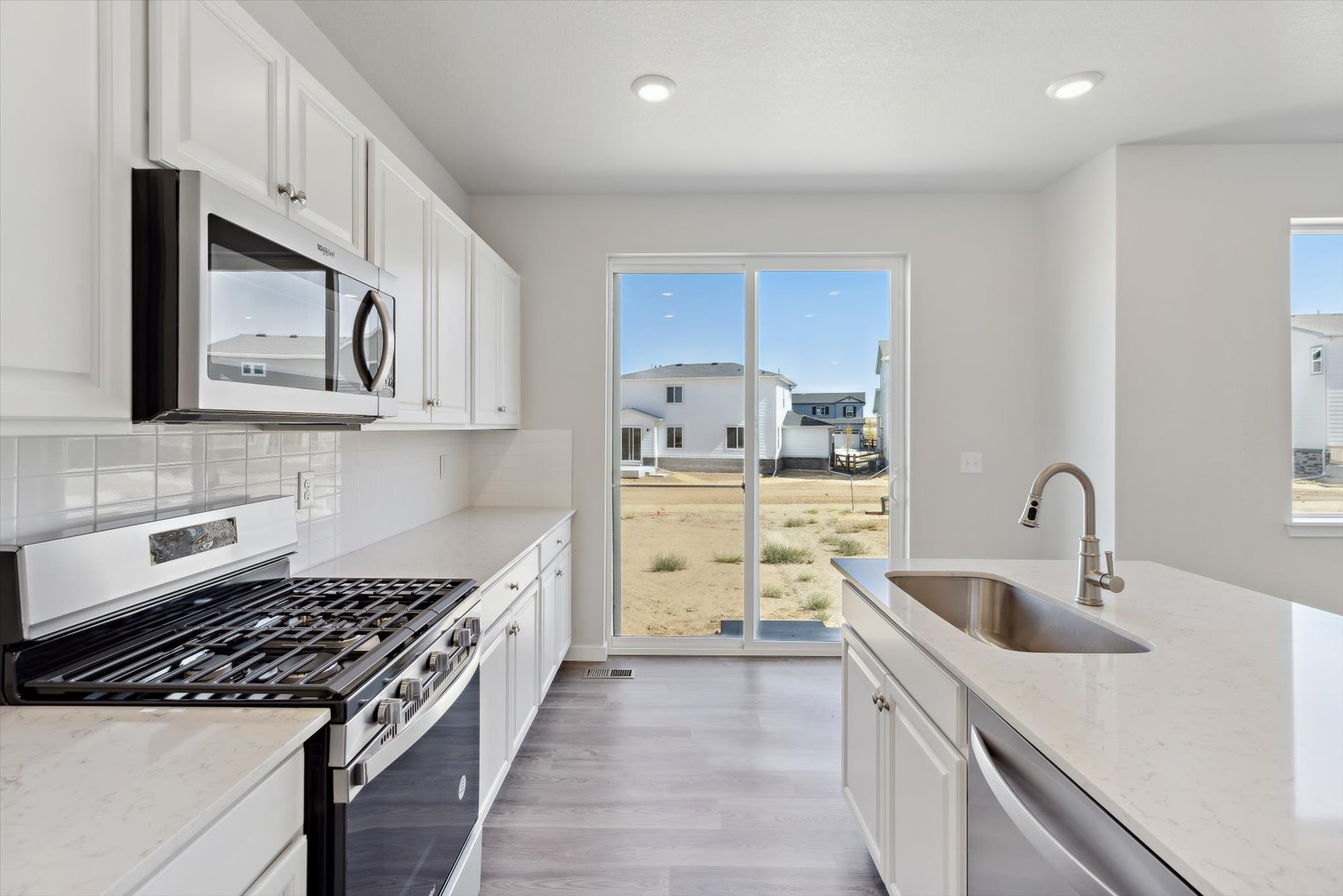 A kitchen with white cabinets.