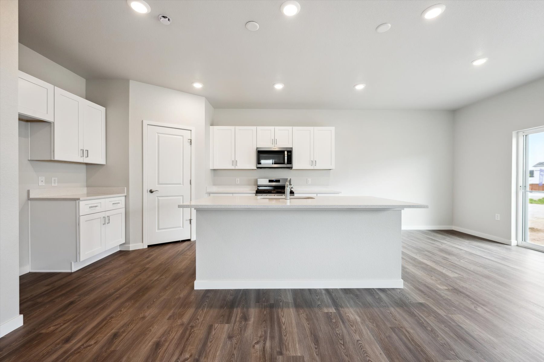 A kitchen with white cabinets.