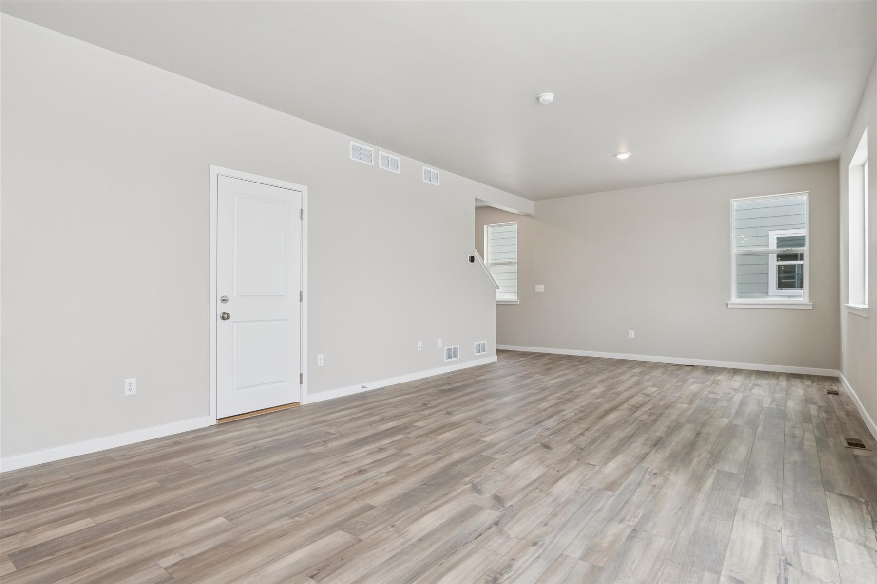 A room with a wood floor and white doors.