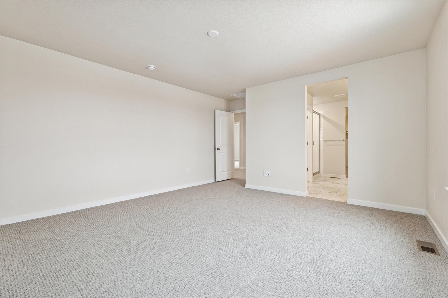 A long hallway with white walls.