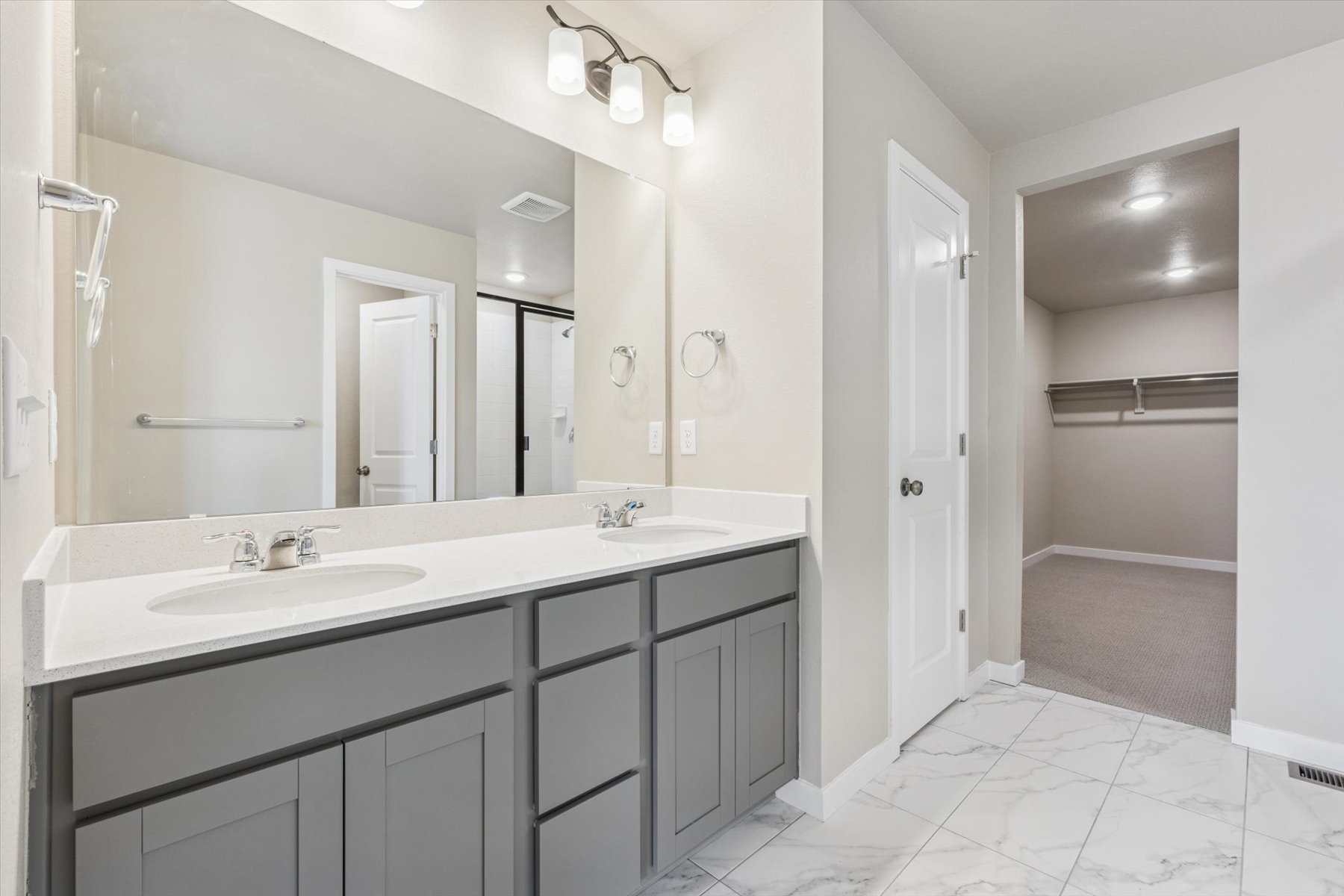 A bathroom with a large mirror.
