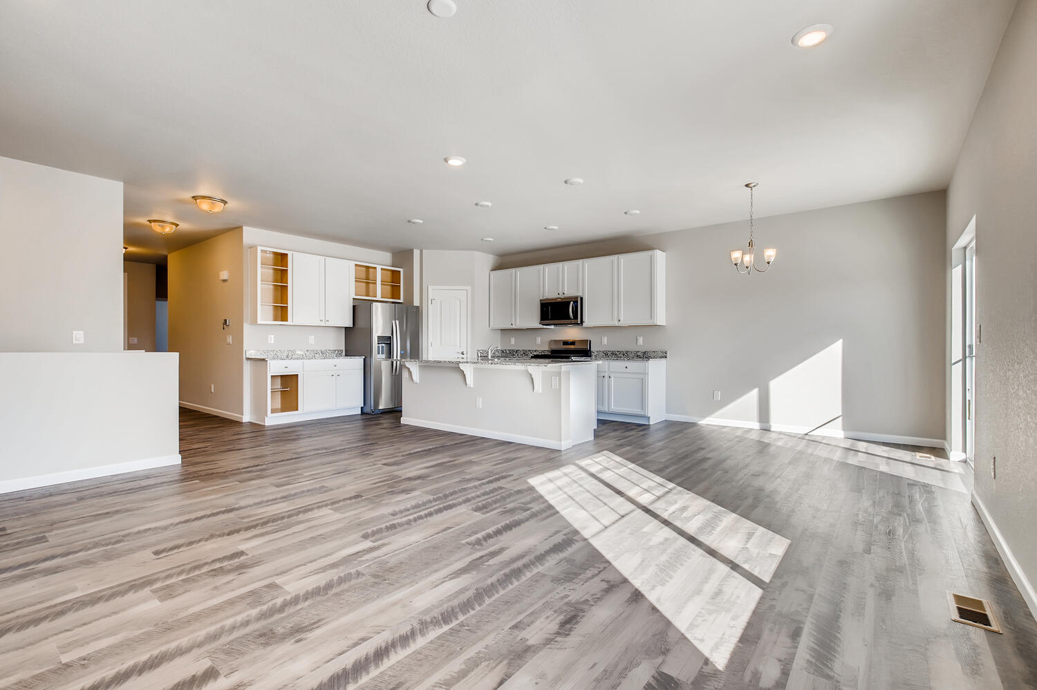 A large kitchen with white cabinets.