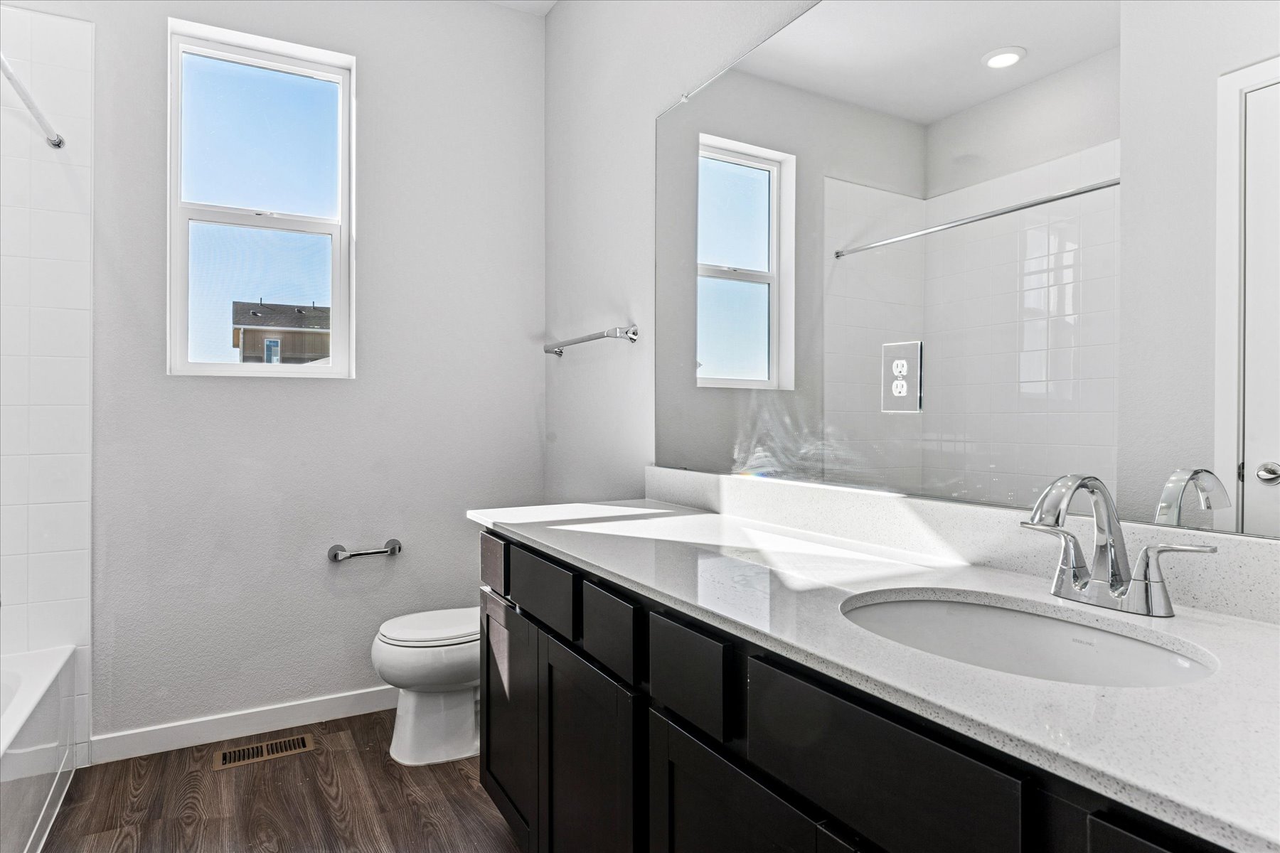 A bathroom with a large mirror.