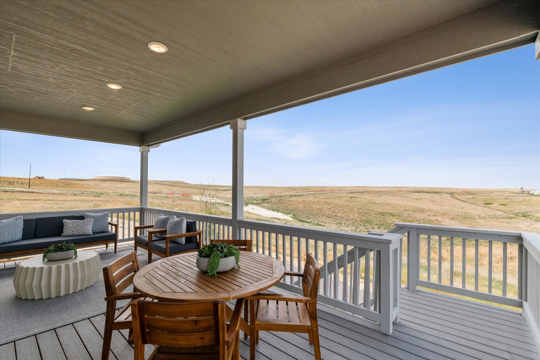 A table and chairs on a deck.