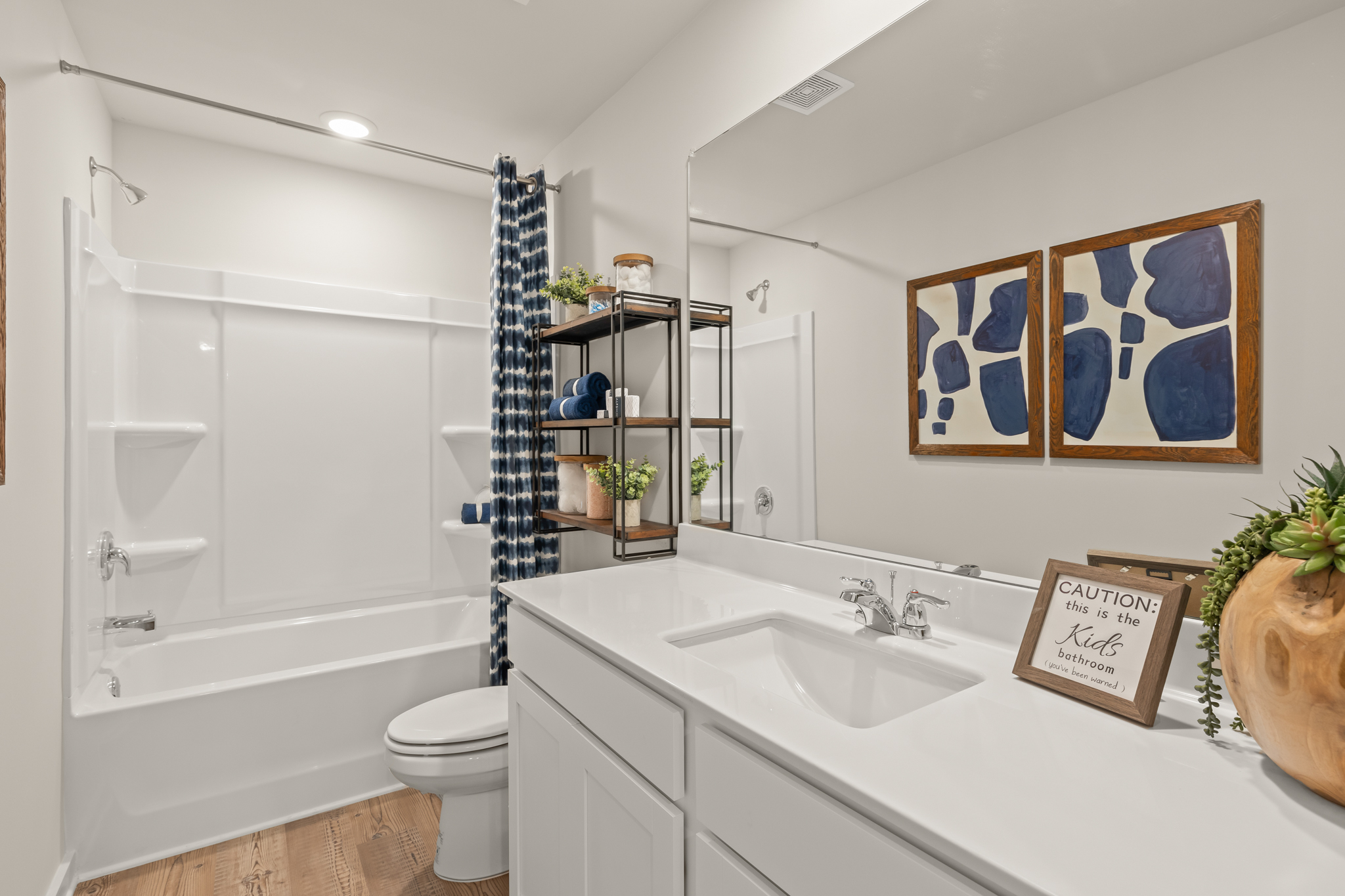 A bathroom with a tub sink and toilet.