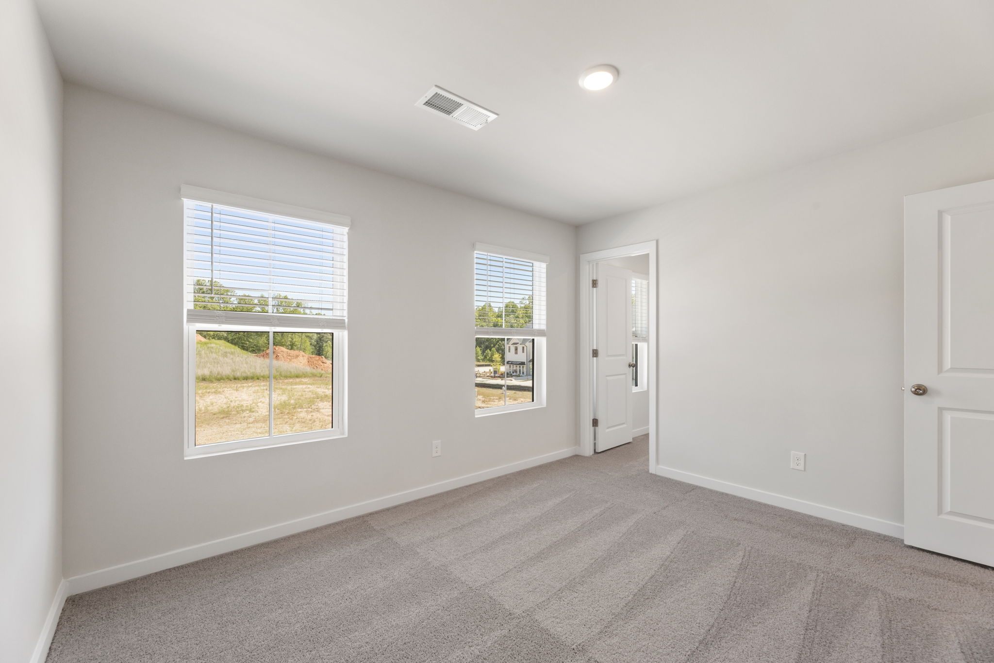 A room with a window and a door.