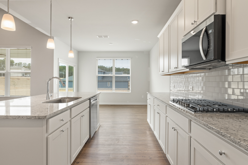 A kitchen with white cabinets.