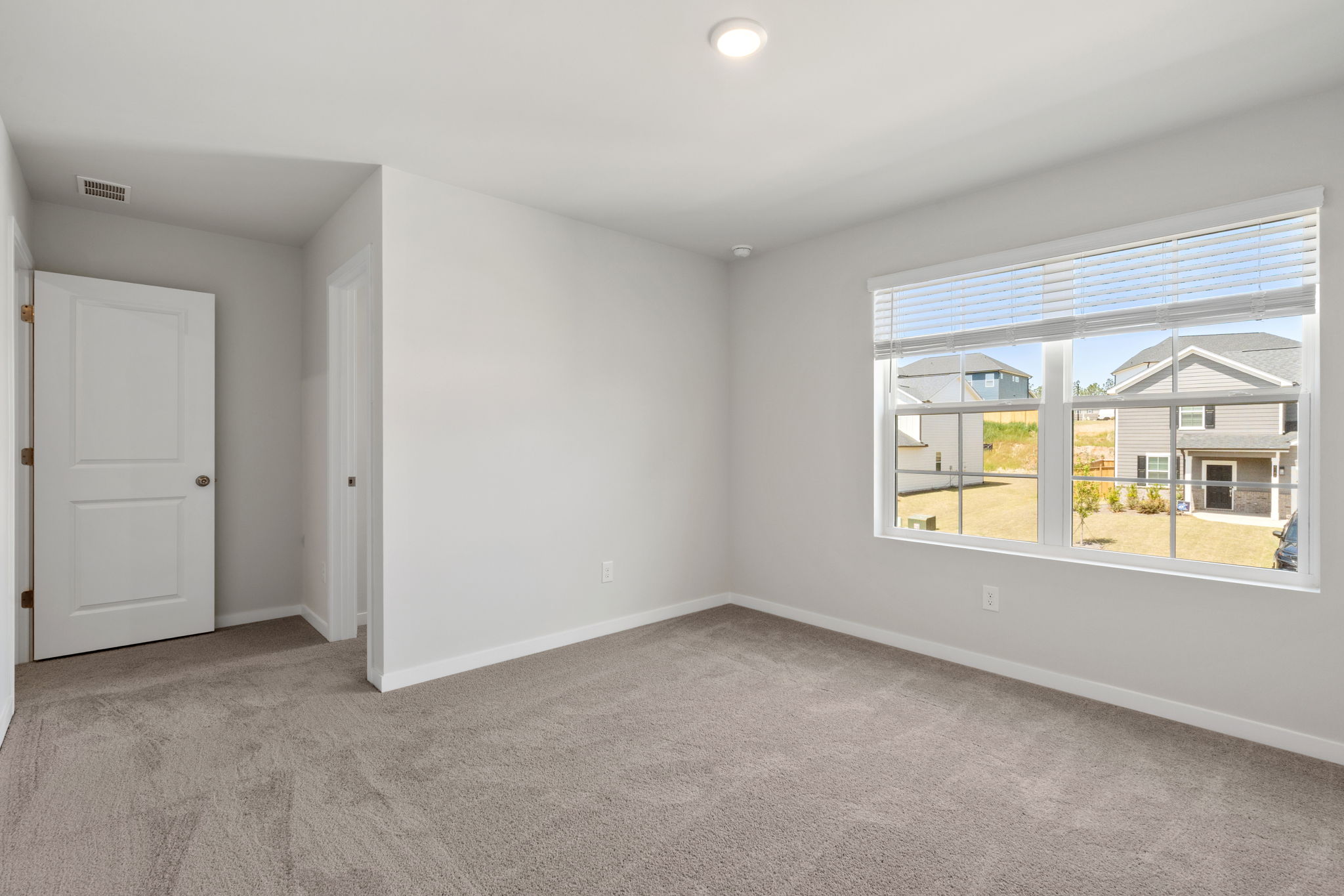 A room with a window and a door.