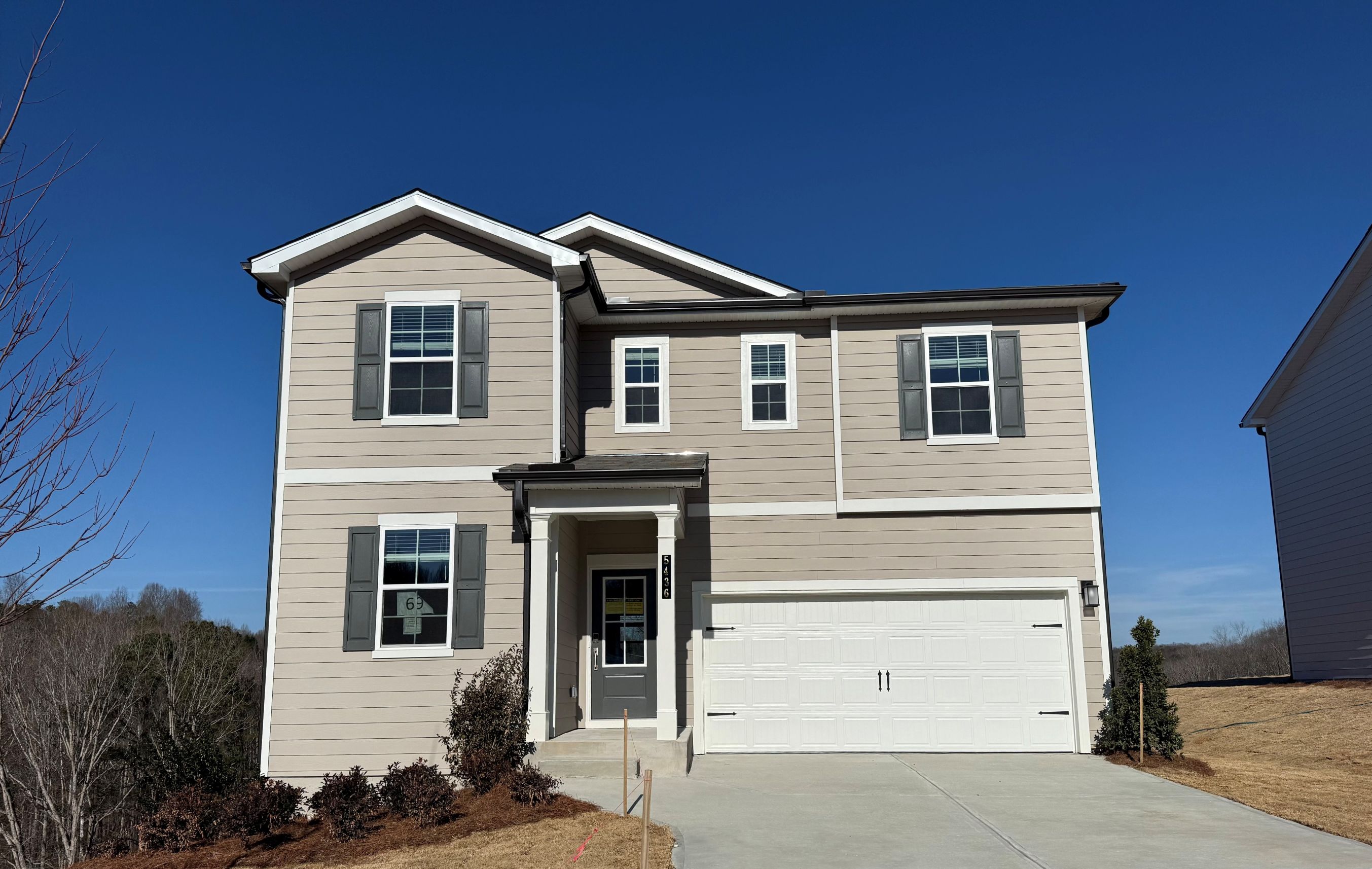 A white house with a garage.
