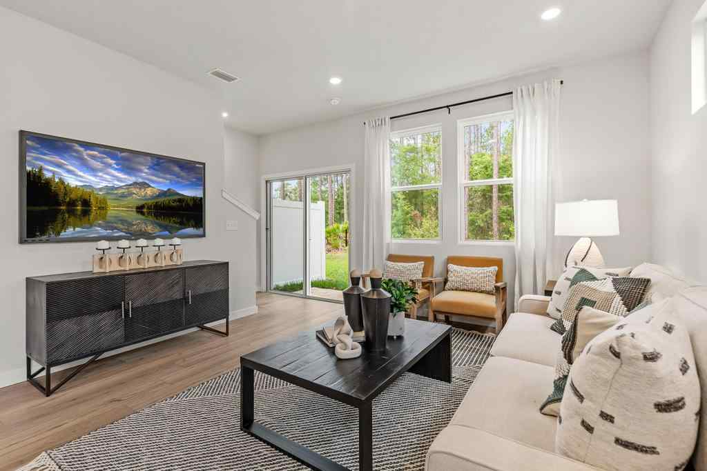A living room with a large television.