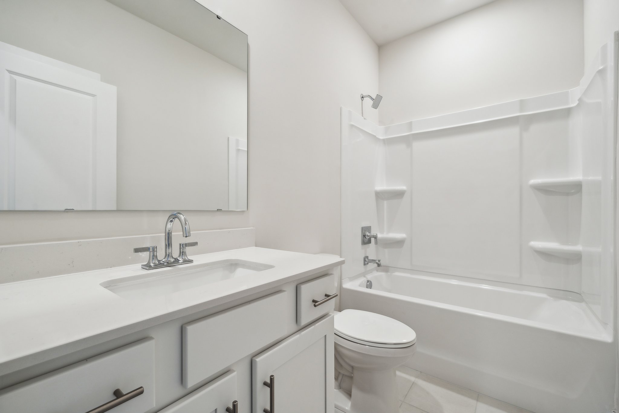 A bathroom with a tub sink and toilet.