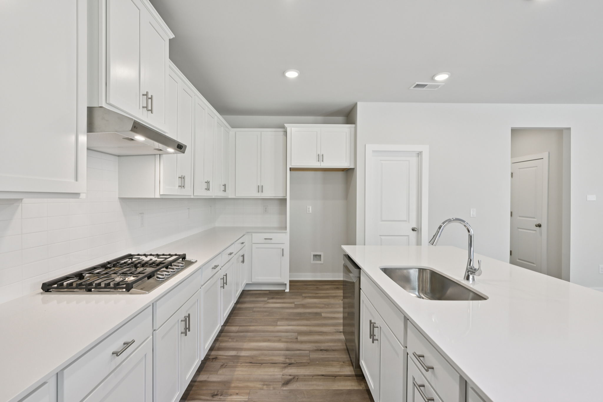 A kitchen with white cabinets.