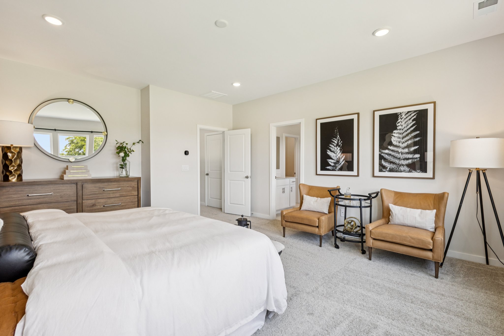 A bedroom with a bed and a chair.