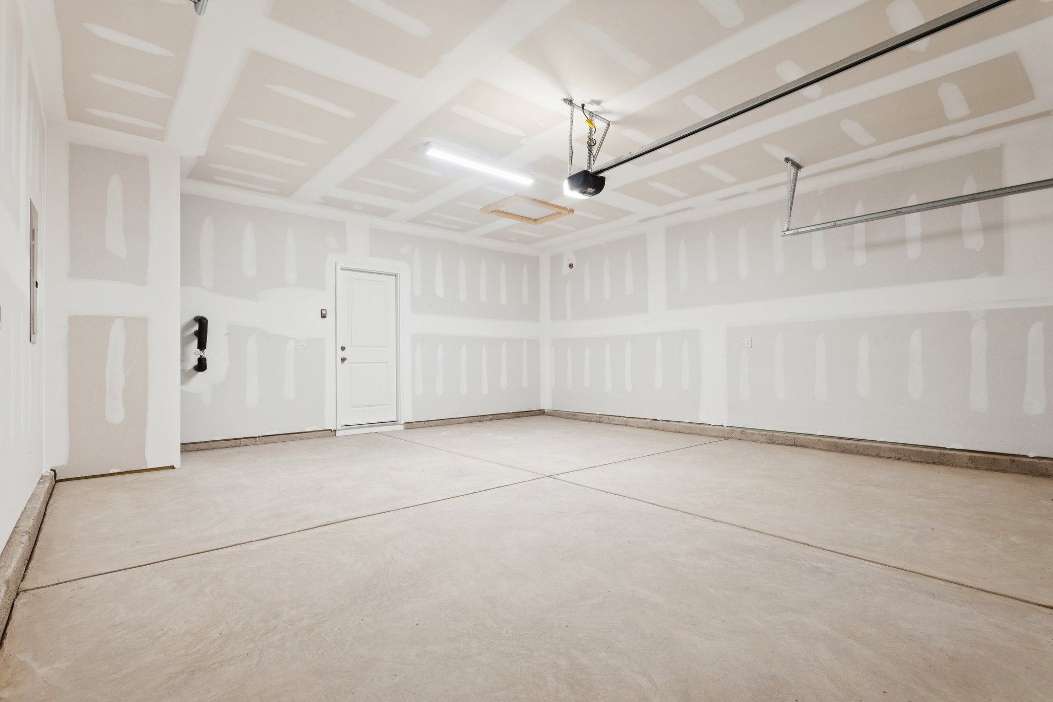 A room with white walls and a wood floor.
