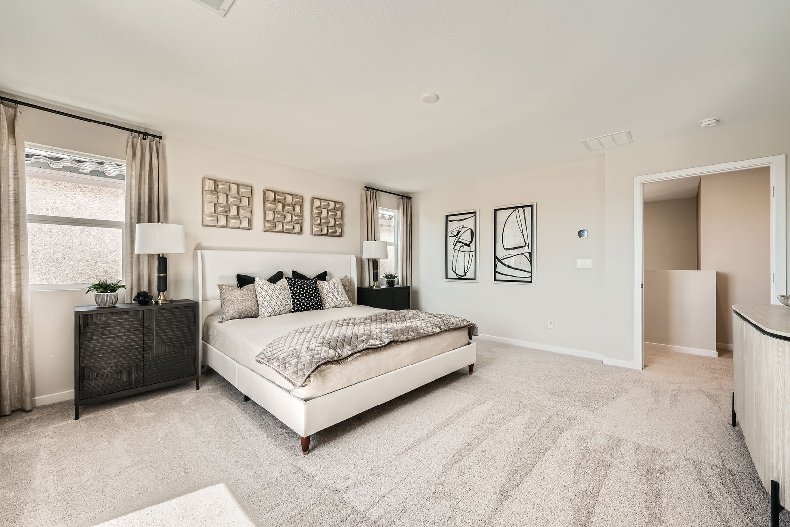 A bedroom with a bed and a dresser.