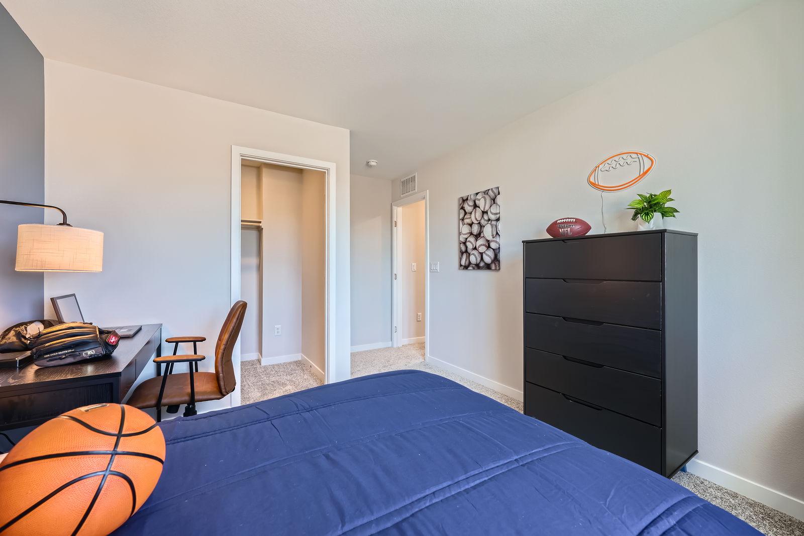 A bedroom with a bed and a dresser.