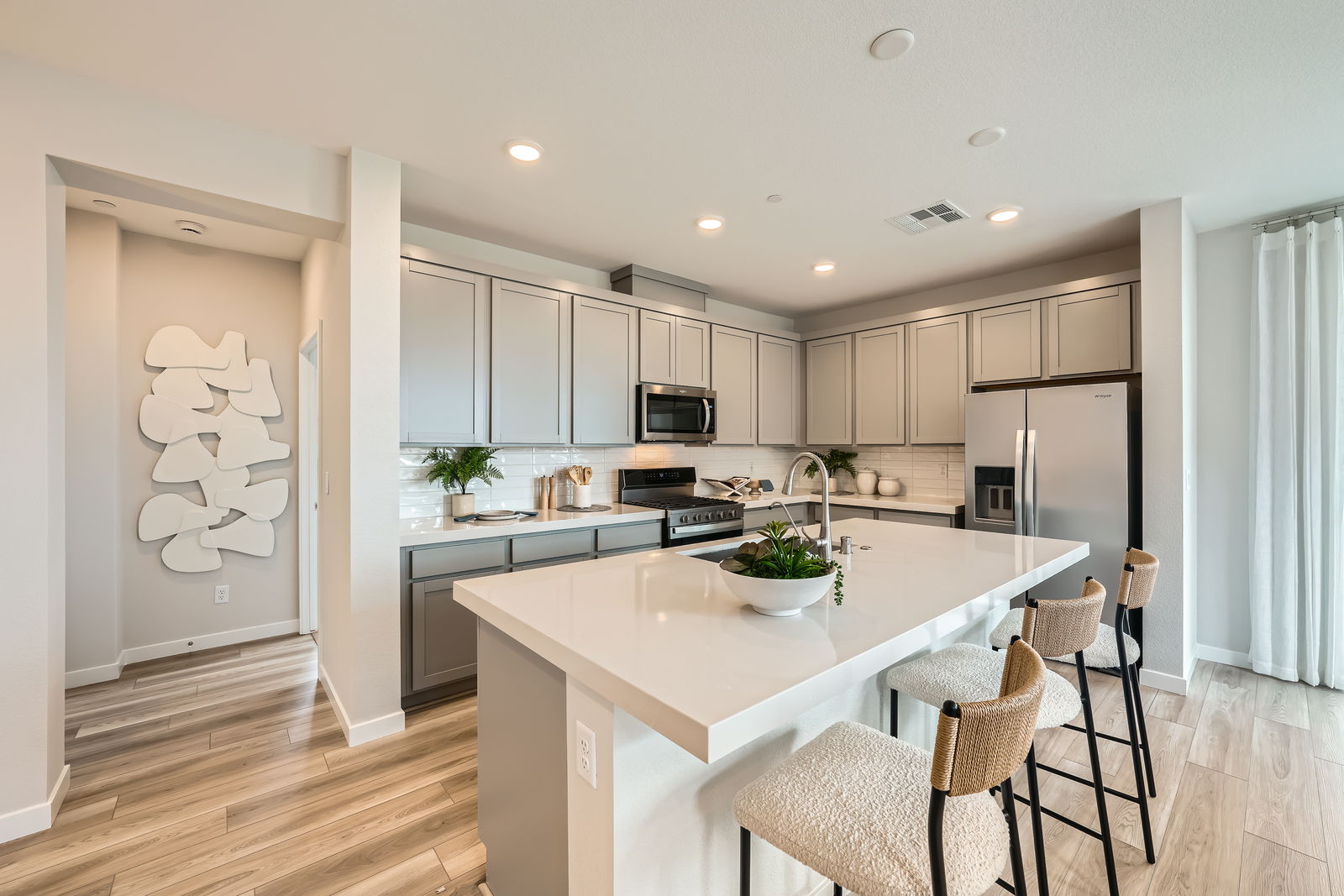A kitchen with white cabinets.