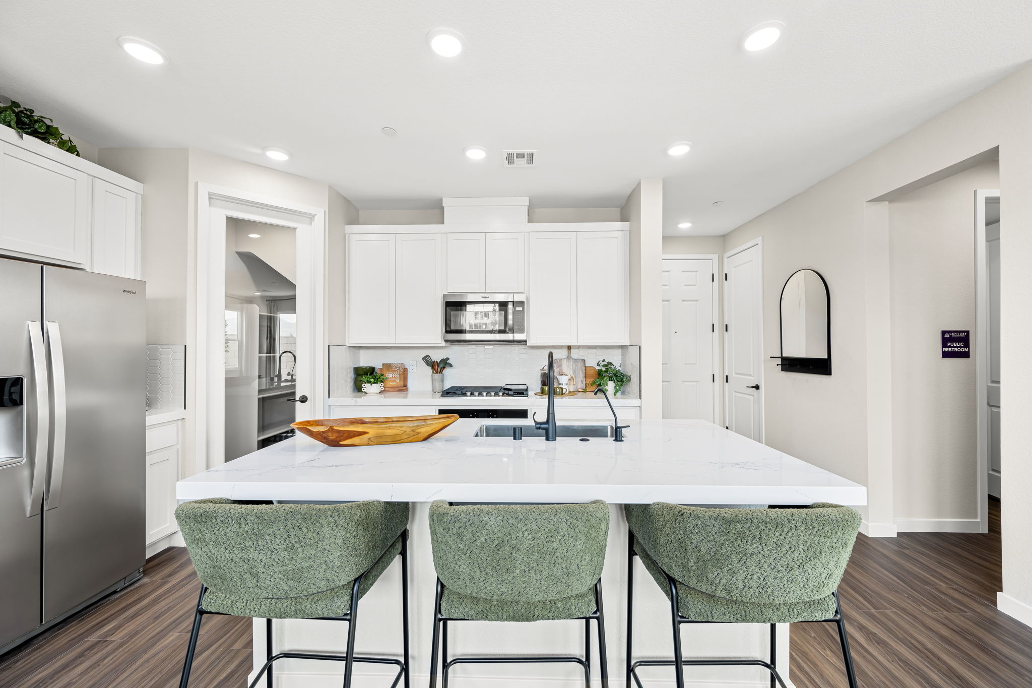 A kitchen with white cabinets.